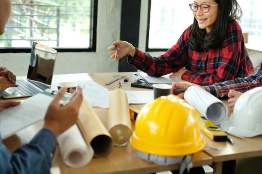 architect engineer interior designer team working discussing on house blueprint of real estate project in meeting. building construction teamwork concept