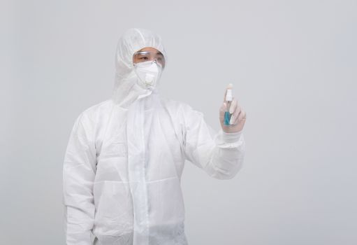 man doctor wearing biological protective uniform suit clothing, mask, gloves with hand alcohol sanitizer dispenser for sanitizing virus bacteria
