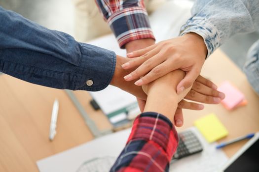 startup man woman joining united hand, business team touching hands together after complete a deal in meeting. unity teamwork partnership corporate concept.