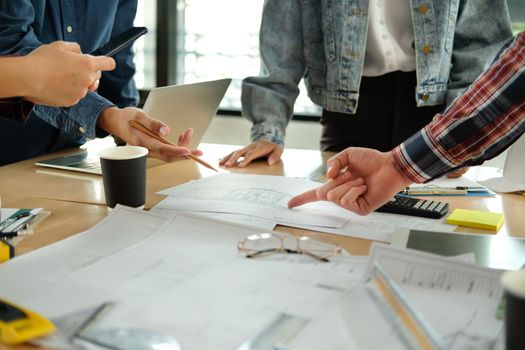 architect engineer interior designer team working discussing on house blueprint of real estate project in meeting. building construction teamwork concept