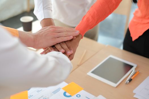 startup man woman joining united hand, business team touching hands together after complete a deal in meeting. unity teamwork partnership corporate concept.