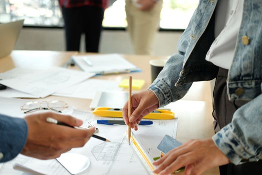 architect engineer interior designer team working discussing on house blueprint of real estate project in meeting. building construction teamwork concept