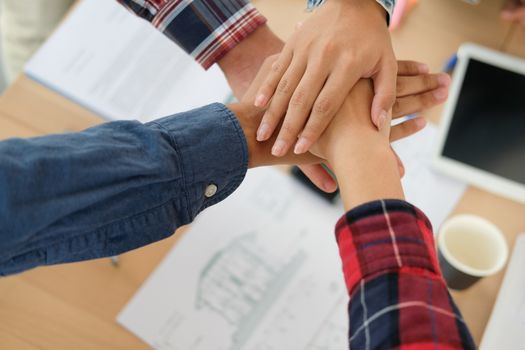 startup man woman joining united hand, business team touching hands together after complete a deal in meeting. unity teamwork partnership corporate concept.