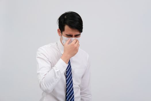 ill businessman man feeling sick, sneezing coughing wearing protective mask against cold flu virus bacteria infection pollution