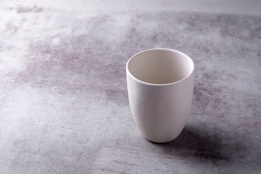Empty blank white ceramic cup on Cement Board.