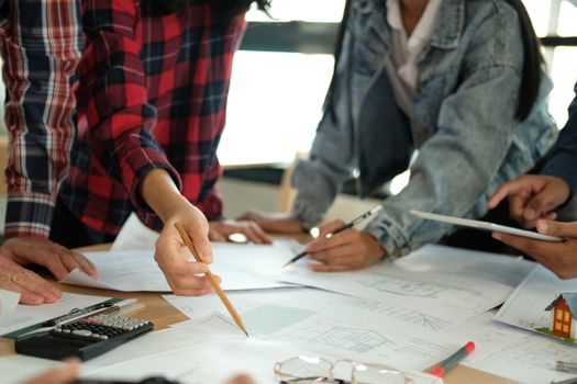 architect engineer interior designer team working discussing on house blueprint of real estate project in meeting. building construction teamwork concept