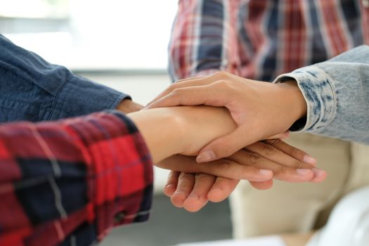 startup man woman joining united hand, business team touching hands together after complete a deal in meeting. unity teamwork partnership corporate concept.