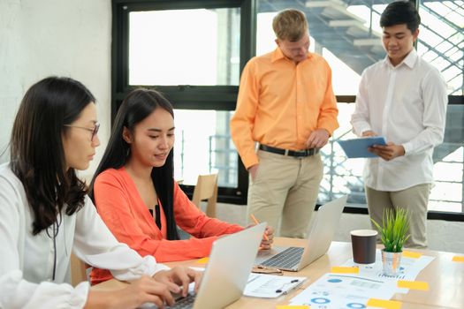 business people discussing on performance revenue in meeting. businessman working with co-worker team. financial adviser analyzing data with investor.