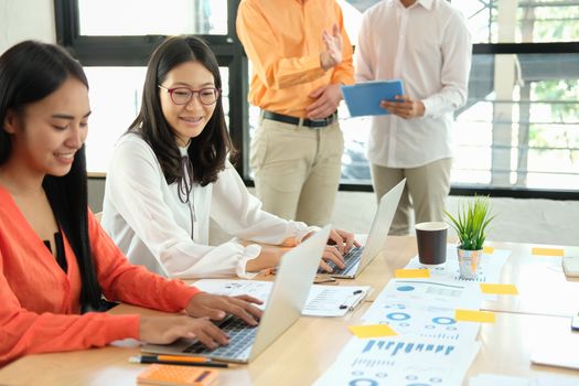 business people discussing on performance revenue in meeting. businessman working with co-worker team. financial adviser analyzing data with investor.