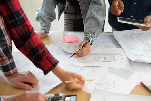 architect engineer interior designer team working discussing on house blueprint of real estate project in meeting. building construction teamwork concept