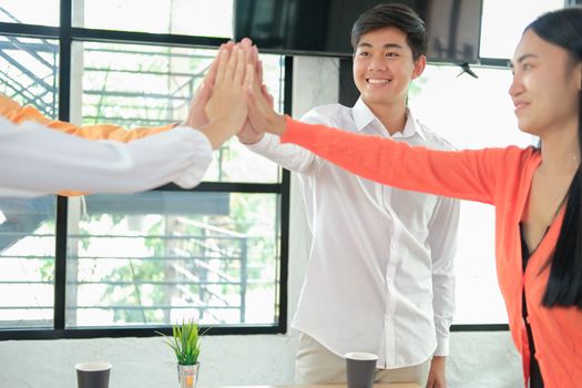 startup man woman joining united hand, business team touching hands together after complete a deal in meeting. unity teamwork partnership corporate concept.