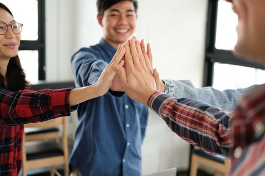 startup man woman joining united hand, business team touching hands together after complete a deal in meeting. unity teamwork partnership corporate concept.