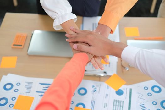 startup man woman joining united hand, business team touching hands together after complete a deal in meeting. unity teamwork partnership corporate concept.