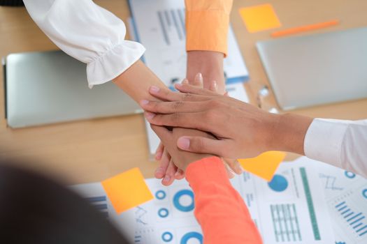 startup man woman joining united hand, business team touching hands together after complete a deal in meeting. unity teamwork partnership corporate concept.