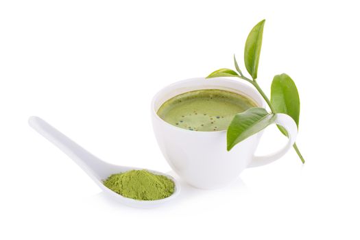 matcha powder in White ceramic spoon and Green tea matcha latte cup isolated on white background.