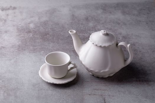 Teapot creamer, Cup and saucer on Cement Board.