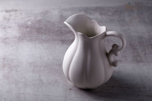 Teapot creamer, Cup and saucer on Cement Board.