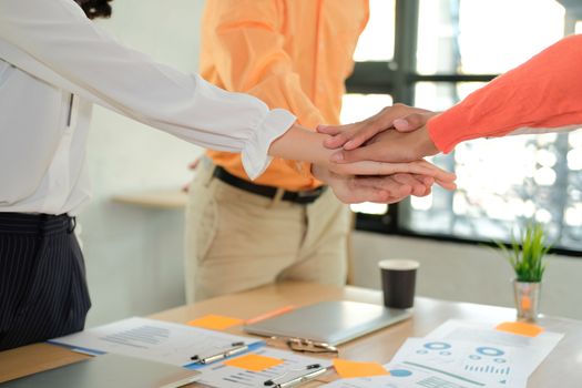 startup man woman joining united hand, business team touching hands together after complete a deal in meeting. unity teamwork partnership corporate concept.