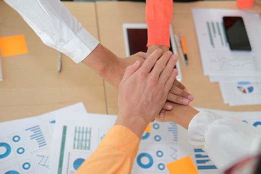 startup man woman joining united hand, business team touching hands together after complete a deal in meeting. unity teamwork partnership corporate concept.