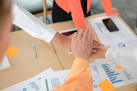 startup man woman joining united hand, business team touching hands together after complete a deal in meeting. unity teamwork partnership corporate concept.