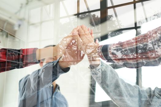 startup man woman joining united hand, business team touching hands together after complete a deal in meeting. unity teamwork partnership corporate concept.