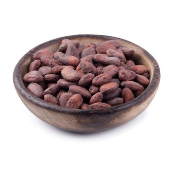 Cocoa fruit in a wooden bowl, raw cacao beans isolated on a white background.