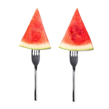 slice of watermelon on a Silver Fork isolated on white background.