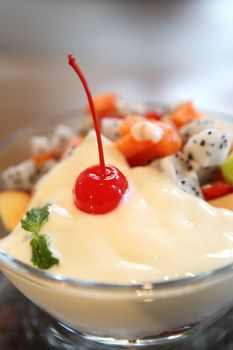 yogurt with fruit on wood background