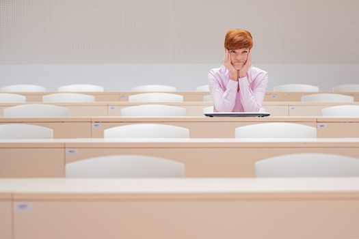 the teacher writes tasks for students into a white laptop