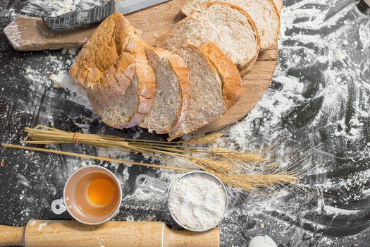 Making bread in Rustic style, Different kinds of bread rolls on wooden table. Kitchen bakery design.