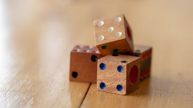 Dice made of wood on wooden table.