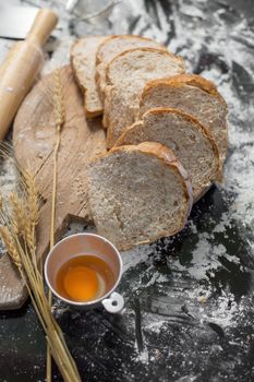 Making bread in Rustic style, Different kinds of bread rolls on wooden table. Kitchen bakery design.