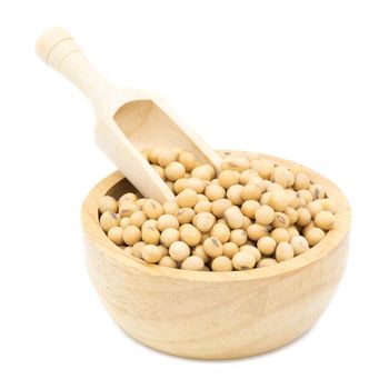 Soybeans in a wooden bowl with wooden spoon on a white background.