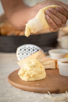 Mashed potatoes in a plate on a wooden table.