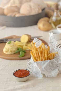French fries with ketchup on wooden background.