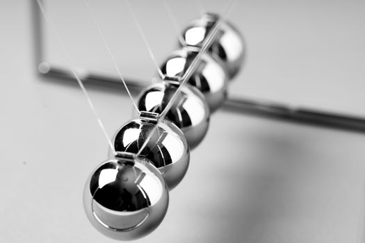 Newtons Cradle balancing balls, business concept in studio