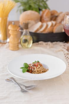 Spaghetti bolognese sauce with beef or pork,cheese,tomatoes and spices on white plate.