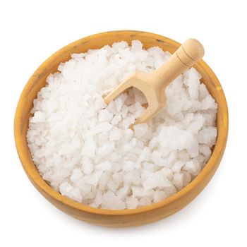 Organic sea white salt tablets in a wooden bowl on white background.