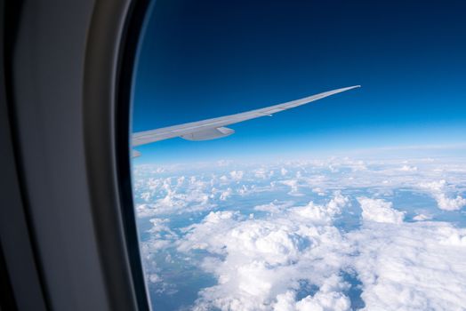 Clouds and sky sunny day through airplane window