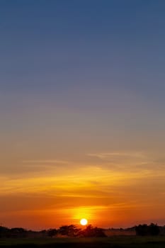 Colorful dramatic sky with Silhouette of tree in the countryside and sunset.