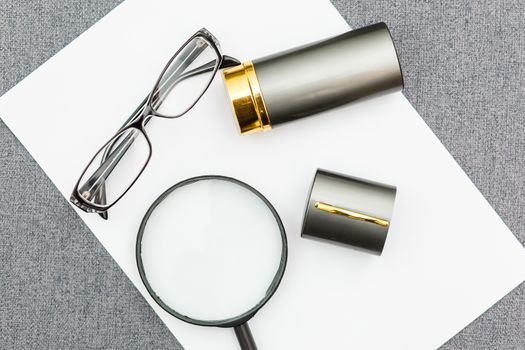 Magnifier,glasses and notebook