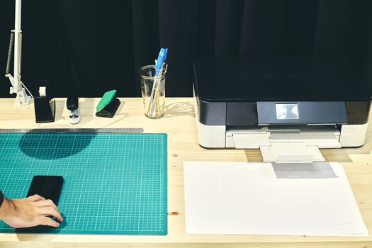 Vision of a desk with its printer and a mobile phone