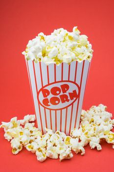 Classic box cinema popcorn on red background