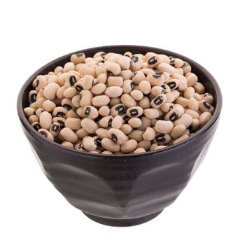 Black-eyed peas in a ceramic bowl isolated on a white background.