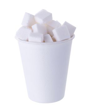 Sugar cubes in wooden spoon isolated on a white background.