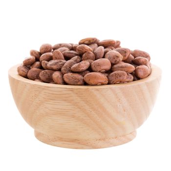 pinto beans  in a wooden bowl isolated on a white background