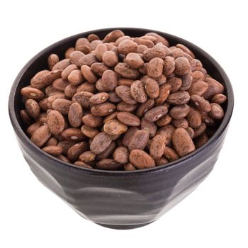 pinto beans  in a ceramic bowl isolated on a white background