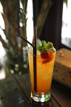 mai tai cocktail with orange cherry fruits on wood background