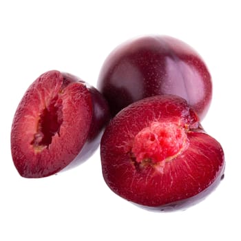 ripe fresh plum with half and slice isolated on white background.