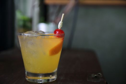 mai tai cocktail with orange cherry fruits on wood background